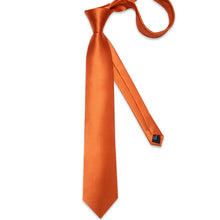 orange tie and pocket square